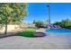 Spacious backyard with a rock waterfall pool, turf, and patio at 6771 Shelter Ln, Las Vegas, NV 89103