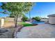 Spacious backyard with a rock waterfall pool, turf, and flagstone patio at 6771 Shelter Ln, Las Vegas, NV 89103