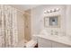 Functional bathroom with a single sink vanity and shower-tub with a patterned shower curtain at 6771 Shelter Ln, Las Vegas, NV 89103