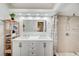 Bathroom featuring a double sink vanity, large mirror and a shower at 6771 Shelter Ln, Las Vegas, NV 89103