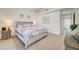 Comfortable bedroom featuring a king-size bed, side tables, and soft, natural light at 6771 Shelter Ln, Las Vegas, NV 89103