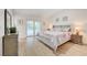 Well-lit bedroom with a king-size bed, sliding glass doors, and neutral decor at 6771 Shelter Ln, Las Vegas, NV 89103