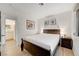 Bright bedroom featuring a Queen bed and laminate flooring adjacent to the bathroom at 6771 Shelter Ln, Las Vegas, NV 89103