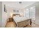 Bright bedroom featuring a Queen bed and laminate flooring next to a window bench at 6771 Shelter Ln, Las Vegas, NV 89103