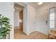 Hallway featuring cabinets, a white door and a window, complete with a decorative house plant at 6771 Shelter Ln, Las Vegas, NV 89103