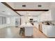 Bright, spacious kitchen featuring white cabinets, a marble island with seating, and stainless steel appliances at 6771 Shelter Ln, Las Vegas, NV 89103