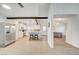 Bright, white kitchen with stainless steel appliances, a center island, and eat in dining area at 6771 Shelter Ln, Las Vegas, NV 89103