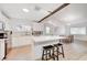 Bright kitchen with white cabinetry, stainless steel appliances, and an island with seating at 6771 Shelter Ln, Las Vegas, NV 89103
