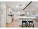 Bright kitchen featuring white cabinets, stainless steel appliances, and an island with seating at 6771 Shelter Ln, Las Vegas, NV 89103