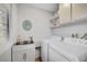 Functional laundry room with a washer and dryer hookup and a utility sink at 6771 Shelter Ln, Las Vegas, NV 89103