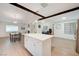 Open floor plan featuring a kitchen island with seating, stainless steel appliances, and a dining area at 6771 Shelter Ln, Las Vegas, NV 89103
