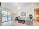 Well-lit living room with views of the backyard, with stylish seating and décor at 6771 Shelter Ln, Las Vegas, NV 89103