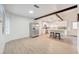 Open-concept living room and kitchen area with stainless-steel appliances and wood floors at 6771 Shelter Ln, Las Vegas, NV 89103