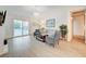 Cozy living room featuring hardwood floors and large windows, with a view of the pool area at 6771 Shelter Ln, Las Vegas, NV 89103