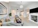 Spacious living room with a fireplace, kitchen and dining area, and plenty of natural light at 6771 Shelter Ln, Las Vegas, NV 89103