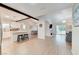 Open-concept living room with wood floors, kitchen with seating, and fireplace in the living area at 6771 Shelter Ln, Las Vegas, NV 89103