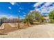 Spacious backyard featuring a garden, mature trees, and a charming pergola-covered patio at 6908 Bienville St, Las Vegas, NV 89131