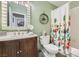Bathroom with stylish vanity, decorative mirror, floral shower curtain, toilet, and gray scale flooring at 6908 Bienville St, Las Vegas, NV 89131