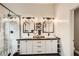 Modern bathroom featuring dual sinks, wood counters, shiplap walls, and a glass-enclosed shower at 6908 Bienville St, Las Vegas, NV 89131