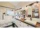 Modern bathroom with dual sinks, wood counters, shiplap walls, and a glass-enclosed marble shower at 6908 Bienville St, Las Vegas, NV 89131