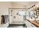 Modern bathroom featuring a glass-enclosed shower, marble tile, black fixtures, and shiplap at 6908 Bienville St, Las Vegas, NV 89131