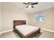 Simple bedroom featuring a dark bed frame, ceiling fan, and a window letting in natural light at 6908 Bienville St, Las Vegas, NV 89131