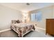 Cozy bedroom featuring a comfortable bed with stylish quilt and a window for natural light at 6908 Bienville St, Las Vegas, NV 89131