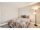 Inviting bedroom featuring carpeted floors, a standing lamp, and a comfortable bed with patterned bedding at 6908 Bienville St, Las Vegas, NV 89131