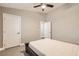 Bedroom with a dark bed frame, ceiling fan, and doors to two rooms at 6908 Bienville St, Las Vegas, NV 89131