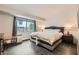 Modern bedroom featuring a large bed, window, white shiplap wall, and contemporary decor at 6908 Bienville St, Las Vegas, NV 89131