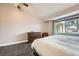Cozy bedroom with a large window, dresser, and queen bed at 6908 Bienville St, Las Vegas, NV 89131