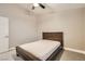 Bedroom with a simple bed frame, ceiling fan, and door leading to another room at 6908 Bienville St, Las Vegas, NV 89131