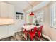 Cozy breakfast nook with bright red chairs and modern overhead lighting at 6908 Bienville St, Las Vegas, NV 89131