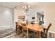 Inviting dining room with a wooden table and seating for six, showcasing a modern lighting fixture at 6908 Bienville St, Las Vegas, NV 89131
