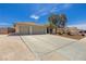Spacious driveway leads to a three-car garage, complemented by desert landscaping, and a secure gated entrance at 6908 Bienville St, Las Vegas, NV 89131