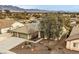 Charming single-story home featuring a three-car garage, desert landscaping, and a tile roof at 6908 Bienville St, Las Vegas, NV 89131