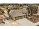 Charming single-story home featuring a three-car garage, desert landscaping, and a tile roof at 6908 Bienville St, Las Vegas, NV 89131