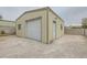 Exterior view of the home's detached garage featuring a white roll-up door at 6908 Bienville St, Las Vegas, NV 89131