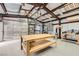 Spacious workshop with metal racking system, overhead hoist, work tables and ceiling fan at 6908 Bienville St, Las Vegas, NV 89131
