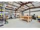 Spacious garage with work tables, storage shelving, and ample room for projects and tools at 6908 Bienville St, Las Vegas, NV 89131