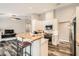 Bright kitchen area with white cabinets, stainless appliances, and breakfast bar at 6908 Bienville St, Las Vegas, NV 89131
