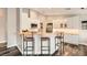Inviting kitchen area with white cabinetry, bar seating, and stainless steel appliances at 6908 Bienville St, Las Vegas, NV 89131