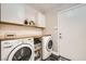 Functional laundry room with washer, dryer, storage cabinets, countertop, and door to the outside at 6908 Bienville St, Las Vegas, NV 89131