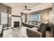 Spacious living room with a stone fireplace, ceiling fan, and comfortable leather seating at 6908 Bienville St, Las Vegas, NV 89131