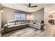 Spacious living room with gray flooring, a large sectional sofa, and a window providing natural light at 6908 Bienville St, Las Vegas, NV 89131