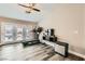 Bright workout space with wood floors, a ceiling fan, a TV, and glass patio doors that let in plenty of light at 6908 Bienville St, Las Vegas, NV 89131
