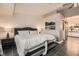 A well-lit main bedroom featuring shiplap accent wall and an ensuite bathroom with modern fixtures at 6908 Bienville St, Las Vegas, NV 89131