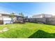 Grassy backyard featuring a trampoline and a hot tub at 7 Sturm St, Henderson, NV 89015