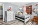 Cozy bedroom with white canopy bed, wood floors, and natural light at 7 Sturm St, Henderson, NV 89015