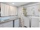 Bright laundry room with granite countertop, drawers and newer washer and dryer at 7 Sturm St, Henderson, NV 89015